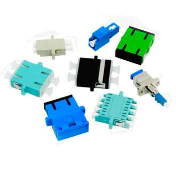 An assortment of fiber optic adapters also called mating sleeves or couplers. In the lower left corner there is a blue duplex singlemode SC adapter, moving clockwise there is then an aqua duplex SC mating sleeve, then a beige duplex multimode LC coupler,